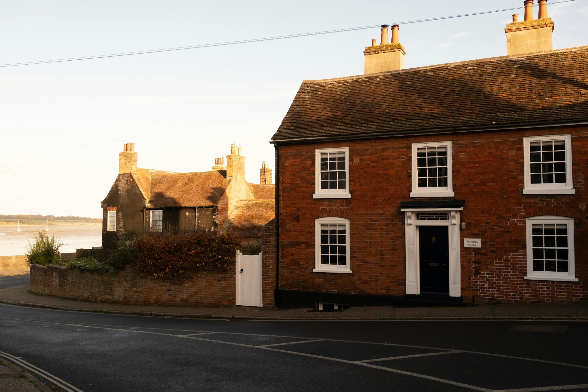 A red brick building sitting on the side of a road