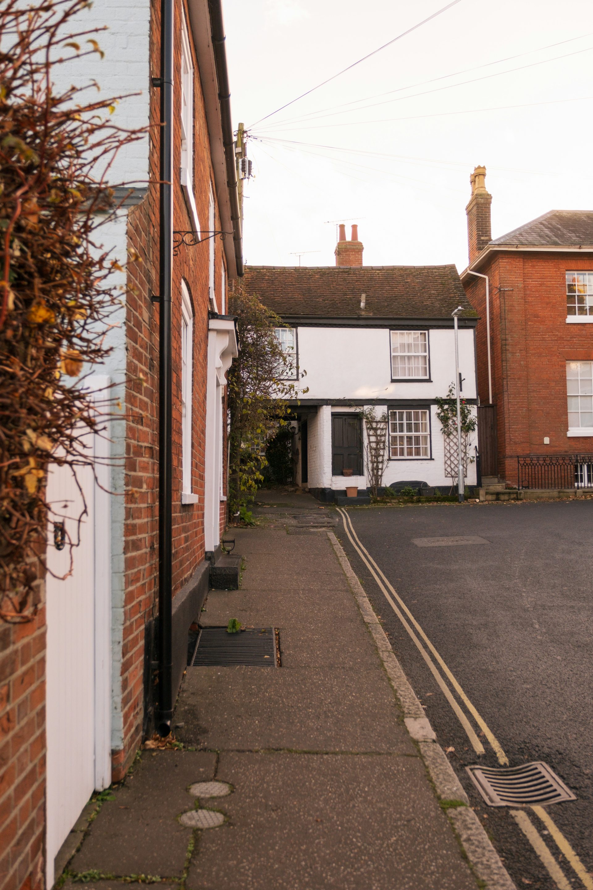 A narrow street with a brick building on the side of it